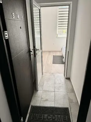 a hallway with a door with a welcome sign on it at Sky in Varna City