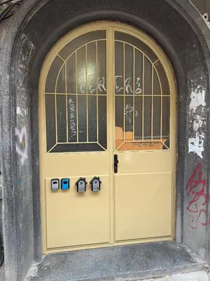a yellow door in a building with graffiti at Sky in Varna City