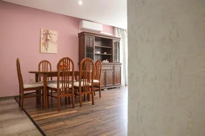 a dining room with a table and chairs at Central Varna Stay with Free Parking by ApartMAX in Varna City
