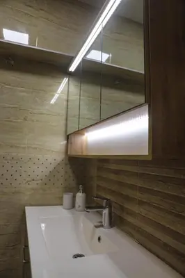 a bathroom with a white sink and a mirror at Central Varna Stay with Free Parking by ApartMAX in Varna City