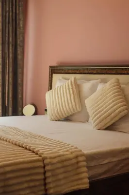 a bed with two pillows and a blanket on it at Central Varna Stay with Free Parking by ApartMAX in Varna City