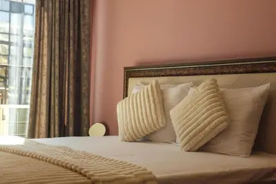 a bedroom with a bed with pillows and a window at Central Varna Stay with Free Parking by ApartMAX in Varna City
