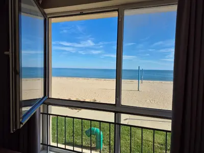 a view of the beach from a window at Апартамент E003 в Обзор Бийч Резорт - усещането да живееш на плажа !!! in Obzor