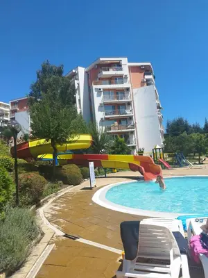 a pool with a water slide in a resort at Fort Noks Grand Resort Wave&Dreams in Sveti Vlas