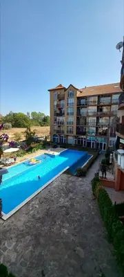 a swimming pool in front of a apartment building at Студия Авангард in Sunny Beach