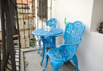 two blue chairs and a table on a balcony at Cozy Flat with Two Bedrooms in Central Varna by Flat Mаnаger in Varna City