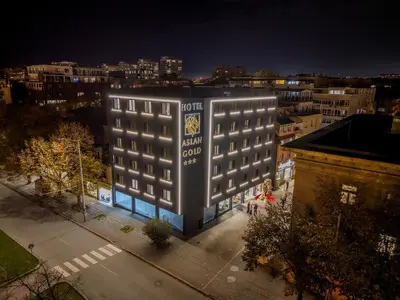 a building with a sign on the side of it at Aslan Gold Hotel in Varna City