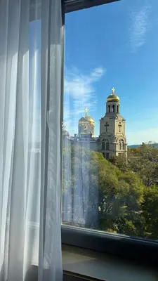 a window with a view of a building at Aslan Gold Hotel in Varna City