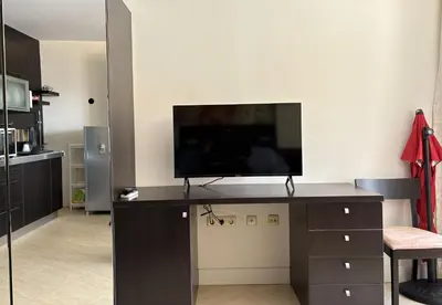 a living room with a television on a desk at Studio F210 - Bulharsko in Aheloy