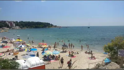 a group of people on a beach with umbrellas at Елегантно Студио В18 в комплекс Одисей, Несебър in Burgas City