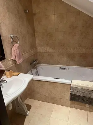 a bathroom with a white tub and a sink at Eco Apartment Cliff in Obzor