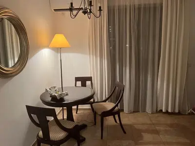 a room with a table and chairs and a mirror at Eco Apartment Cliff in Obzor