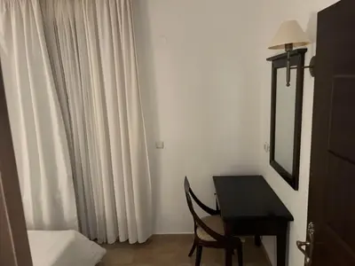 a room with a table and a mirror and a desk at Eco Apartment Cliff in Obzor