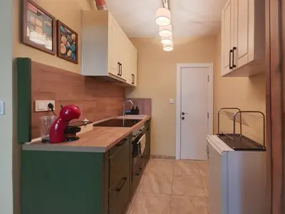 a kitchen with a red appliance on the counter at PasTelo - 6 min to the Beach & Promenade in Varna City