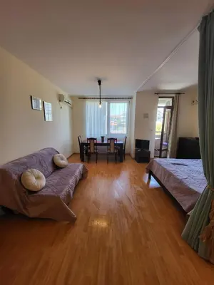 a living room with a couch and a table at Garden of Eden studio in Sveti Vlas