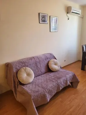 a purple couch with two pillows on top of it at Garden of Eden studio in Sveti Vlas