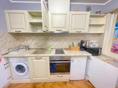 a kitchen with white cabinets and a sink and a dishwasher at 'Golden Bird' Apartment, 2 Bedrooms, Super Central in Burgas City