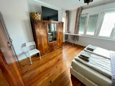 a living room with a bed and a wooden floor at 'Sea South' Apartment, Super Central, Vintage Style, 1BDR in Burgas City