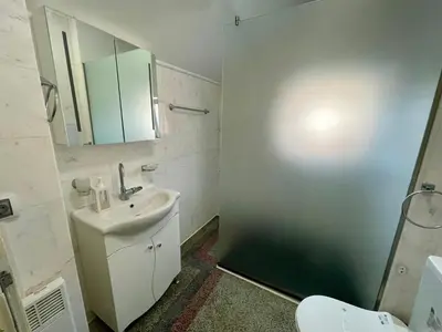 a bathroom with a sink and a toilet and a mirror at 'Sea South' Apartment, Super Central, Vintage Style, 1BDR in Burgas City