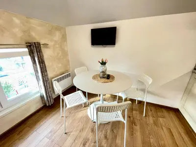 a dining room with a table and chairs and a tv at 'Sea South' Apartment, Super Central, Vintage Style, 1BDR in Burgas City