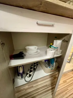 a cupboard with toiletries and other items in it at 'The Conch' Room with Private Entrance and Bathroom in Burgas City