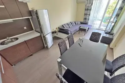 a kitchen and living room with a table and chairs at Apartments Nessebar in Nesebar