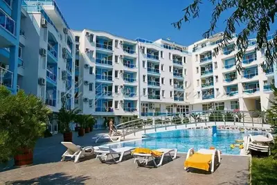 a large white apartment building with a swimming pool at Apartments Nessebar in Nesebar