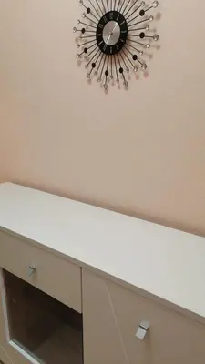 a mirror hanging above a dresser in a room at апартамент Климент in Varna City