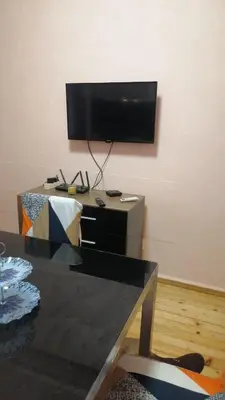 a living room with a flat screen tv on a wall at апартамент Климент in Varna City