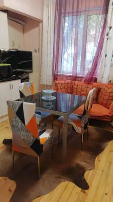 a living room with a table and chairs and a couch at апартамент Климент in Varna City