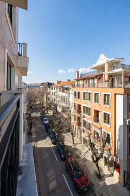 a view from a balcony of a street with parked cars at Chic Downtown Flat in Varna City