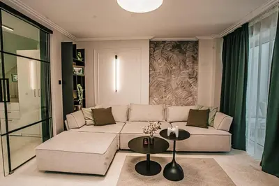 a living room with a couch and a table at The Loft - Parking - Washer&Dryer - Port view - Balcony in Burgas City