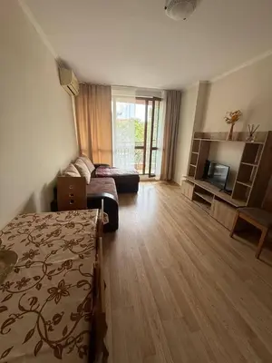 a bedroom with a bed and a living room at Pacific 3 Apartments in Sunny Beach