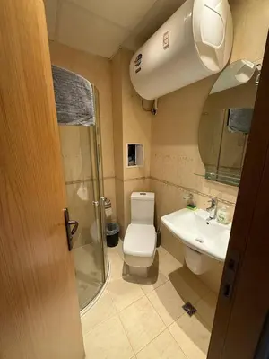 a bathroom with a shower and a toilet and a sink at Pacific 3 Apartments in Sunny Beach