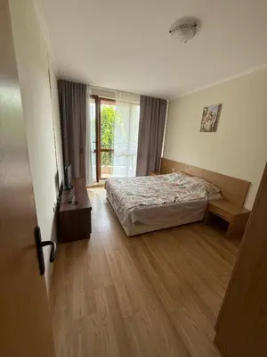 a bedroom with a bed and a large window at Pacific 3 Apartments in Sunny Beach