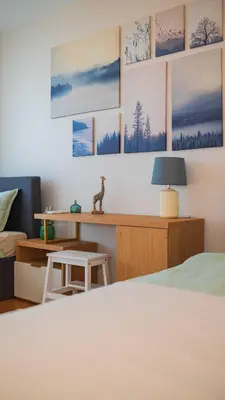 a bedroom with a bed and a desk with a lamp at Harmony Delux Apartment -Free parking in Burgas City