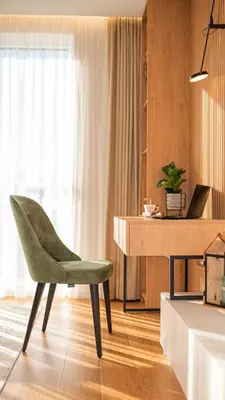 a green chair sitting in front of a desk at Harmony Delux Apartment -Free parking in Burgas City