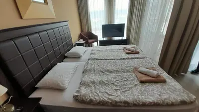a bedroom with two beds with towels on them at Studio Royal Beach Barcello in Sunny Beach