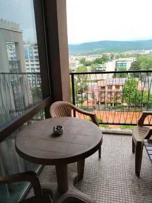 a table and chairs on a balcony with a view at Studio Royal Beach Barcello in Sunny Beach