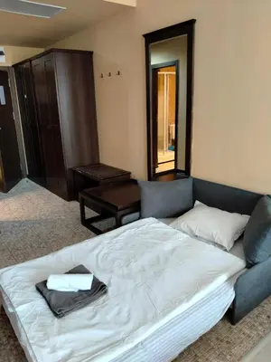 a bedroom with a large bed and a couch at Studio Royal Beach Barcello in Sunny Beach