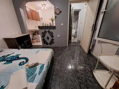 a room with a bed and a tv in it at Бюджетна стая за двама in Pomorie