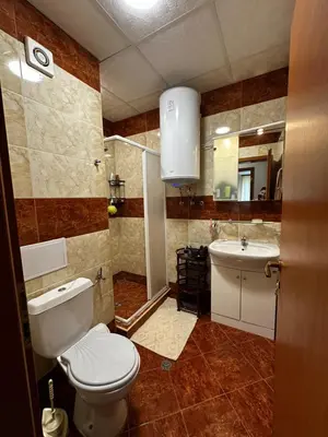 a bathroom with a toilet and a sink at Have a Good Rest Apartments in Sveti Vlas
