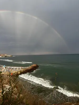 a view of a beach with people and the ocean at Have a Good Rest Apartments in Sveti Vlas