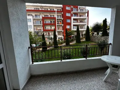 a balcony with a view of a building at Have a Good Rest Apartments in Sveti Vlas