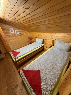 a room with two beds in a log cabin at Apartment With 2 Bedrooms - Magic Woods