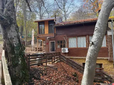 a wooden house with a fence in front of it at Apartment With 2 Bedrooms - Magic Woods