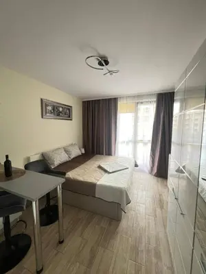 a bedroom with a bed and a table and a window at Coastera Group Cascadas 8 in Sunny Beach