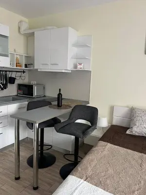 a kitchen with a table and two chairs and a bed at Coastera Group Cascadas 8 in Sunny Beach