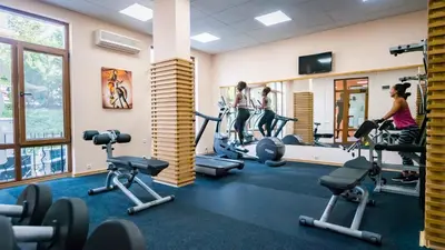 a gym with several people exercising on tread machines at Premier Fort Club Hotel - Full Board in Sunny Beach