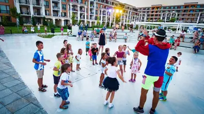 a group of children standing around in a courtyard at Premier Fort Club Hotel - Full Board in Sunny Beach